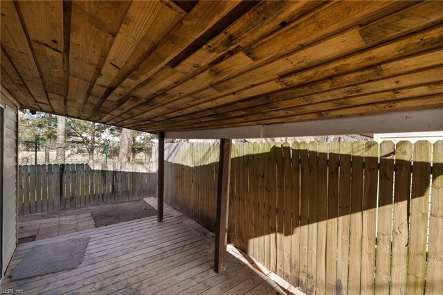 wooden terrace featuring a fenced backyard