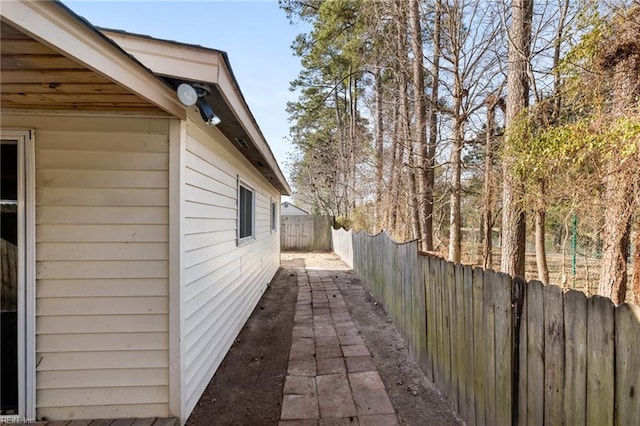 view of side of home with fence