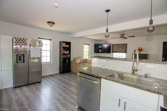 8123 Kenwood Dr, Norfolk, VA 23518 - kitchen featuring stainless steel appliances, a sink, open floor plan, a ceiling fan, and tasteful backsplash