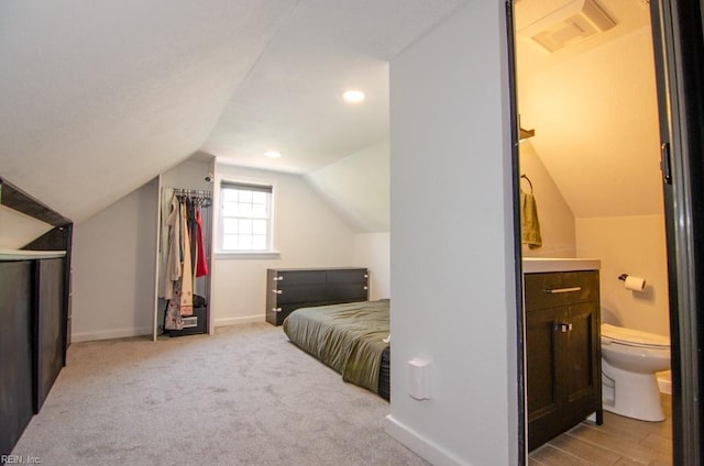 8123 Kenwood Dr, Norfolk, VA 23518 - bedroom featuring lofted ceiling, baseboards, ensuite bath, and light colored carpet