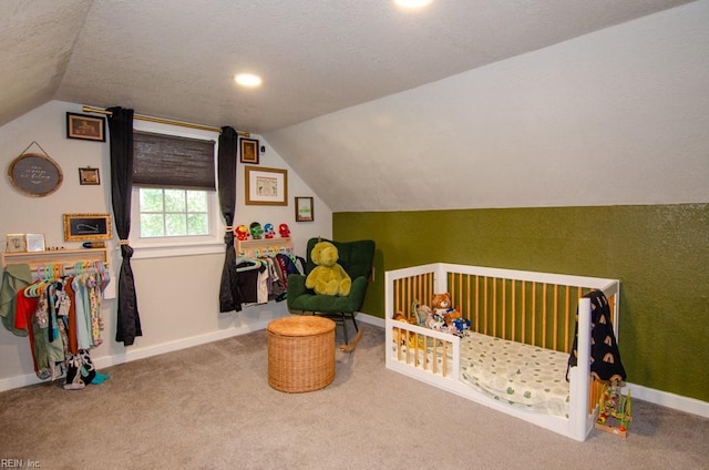 8123 Kenwood Dr, Norfolk, VA 23518 - carpeted bedroom featuring vaulted ceiling, baseboards, a textured ceiling, and a crib