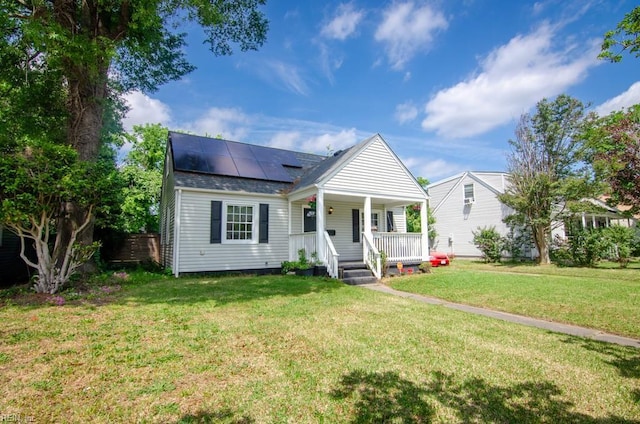 8123 Kenwood Dr, Norfolk, VA 23518 - bungalow featuring a porch, solar panels, a front yard, and roof with shingles