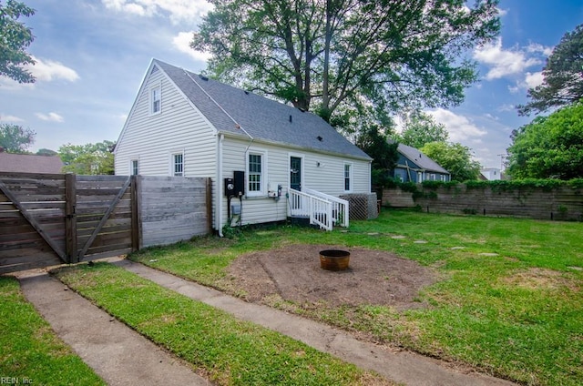 8123 Kenwood Dr, Norfolk, VA 23518 - view of front of home featuring an outdoor fire pit, a shingled roof, and a gate