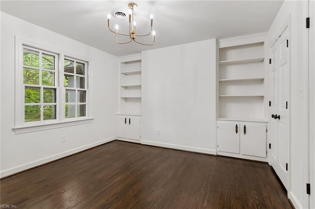 unfurnished dining area with baseboards, dark wood finished floors, an inviting chandelier, and built in features