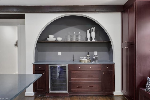 bar with wet bar, dark wood-style flooring, and wine cooler