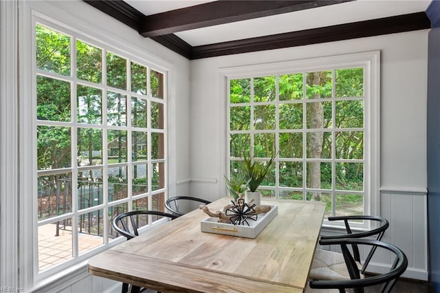 dining space featuring beam ceiling
