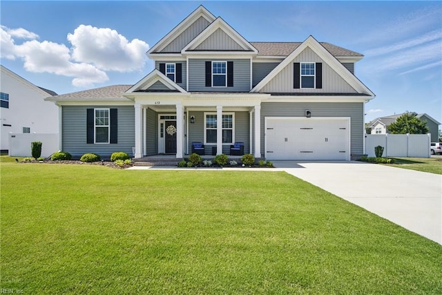 craftsman inspired home featuring concrete driveway, board and batten siding, a porch, and a front yard