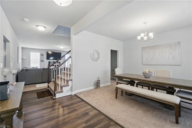 dining space featuring stairway, an inviting chandelier, baseboards, and dark wood finished floors
