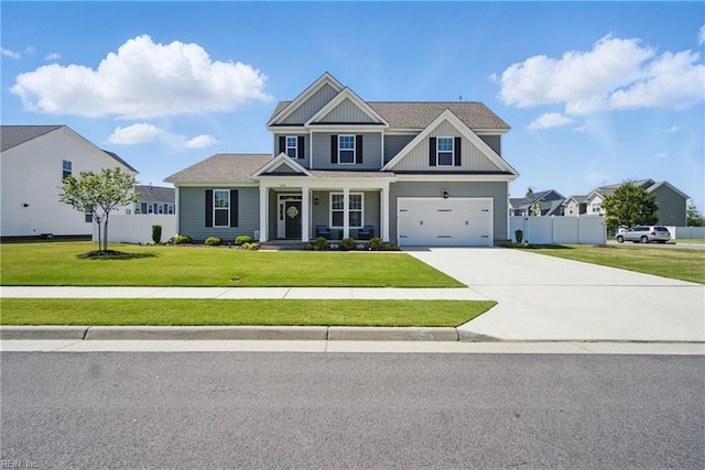 craftsman inspired home with concrete driveway, a porch, fence, and a front yard