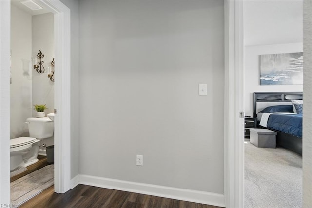 bedroom featuring baseboards and dark wood-style floors