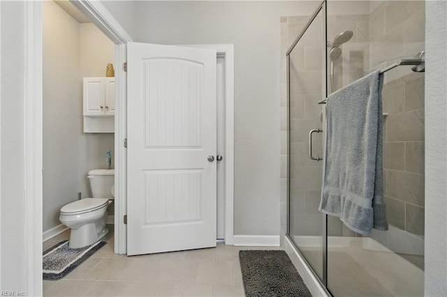 bathroom with toilet, baseboards, tile patterned flooring, and a shower stall