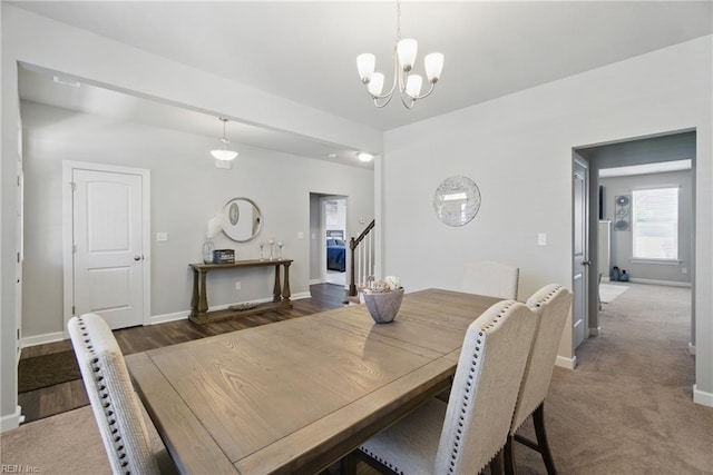 dining room with a chandelier, stairs, and baseboards