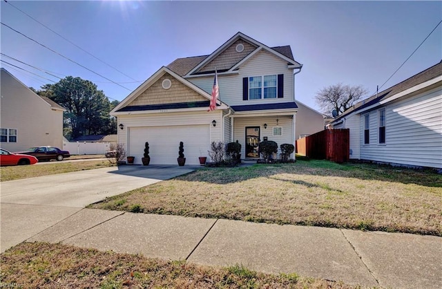 7463 Diven St, Norfolk, VA 23505 - view of front of house featuring concrete driveway, a front lawn, a garage, and fence