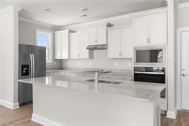 kitchen featuring appliances with stainless steel finishes, a sink, light wood-style flooring, white cabinets, and ornamental molding