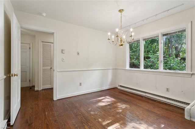 unfurnished dining area with baseboards, a notable chandelier, a baseboard radiator, and hardwood / wood-style flooring