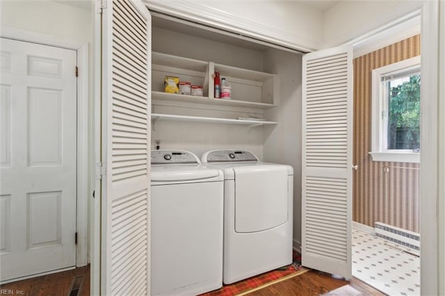 washroom with washing machine and clothes dryer, laundry area, and dark wood-style floors