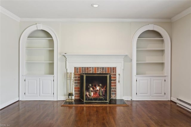 unfurnished living room featuring wood finished floors, built in shelves, a fireplace, crown molding, and baseboard heating