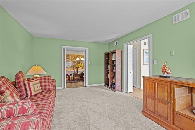 carpeted living room with baseboards and visible vents