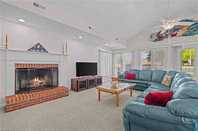 living room with carpet flooring, ceiling fan, visible vents, vaulted ceiling, and a fireplace