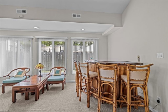 interior space with a bar, carpet, visible vents, and recessed lighting