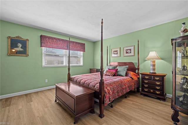 bedroom with baseboards and wood finished floors