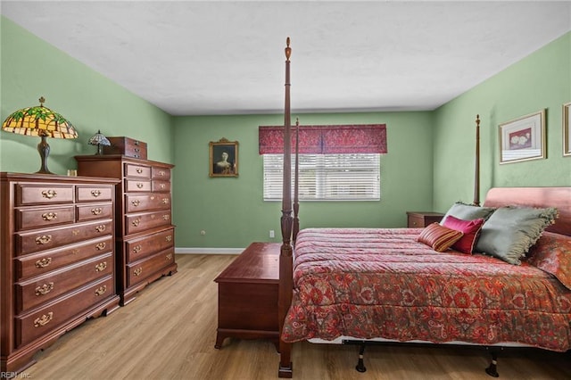 bedroom with wood finished floors and baseboards