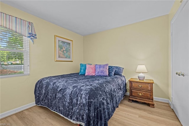 bedroom featuring baseboards and wood finished floors