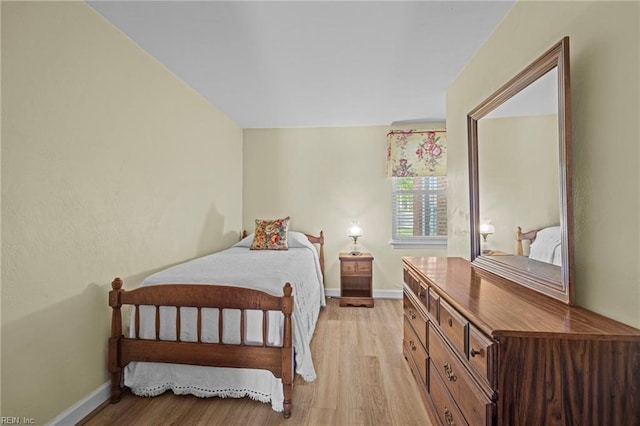 bedroom featuring baseboards and light wood-style floors