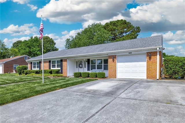 ranch-style home featuring a garage, a front lawn, concrete driveway, a porch, and brick siding