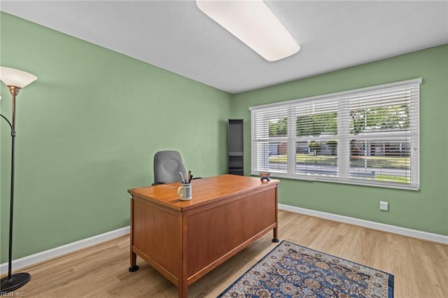 home office featuring baseboards and light wood-style flooring