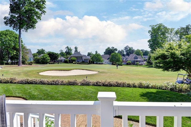 view of green lawn with a residential view