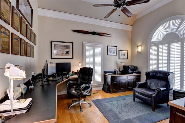 home office featuring a ceiling fan, light wood-style flooring, ornamental molding, and baseboards