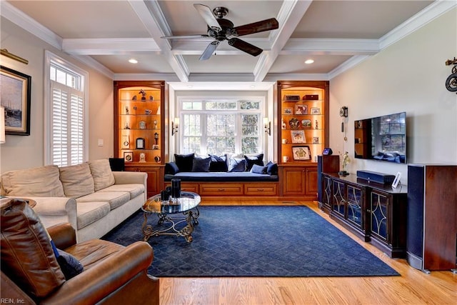 living area featuring beamed ceiling, wood finished floors, crown molding, ceiling fan, and coffered ceiling