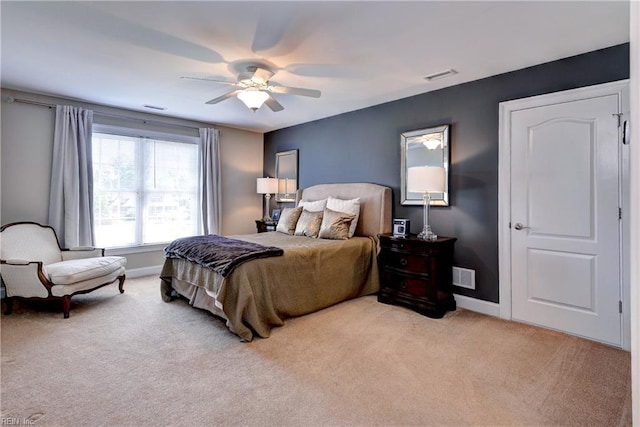 bedroom featuring light carpet, baseboards, and a ceiling fan