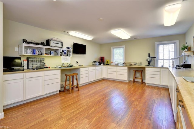 kitchen with light wood-style floors, white cabinets, and light countertops