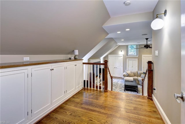additional living space featuring wood finished floors, vaulted ceiling, ceiling fan, and recessed lighting