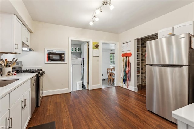 kitchen with under cabinet range hood, light countertops, appliances with stainless steel finishes, and white cabinetry