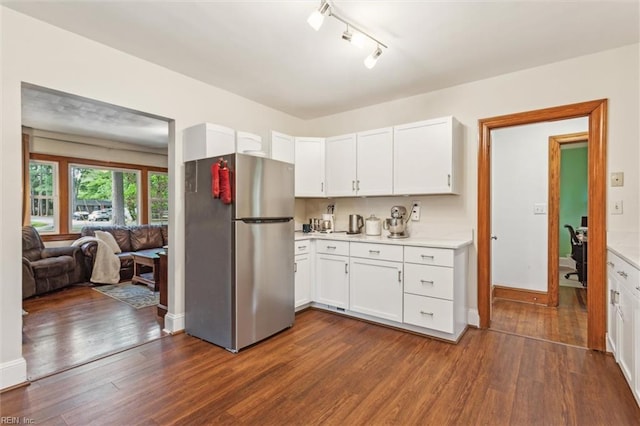 kitchen featuring freestanding refrigerator, light countertops, white cabinets, and dark wood-style floors
