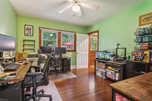 home office featuring dark wood-style floors, baseboards, and a ceiling fan