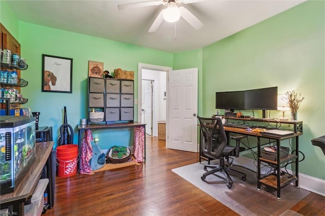 office space featuring a ceiling fan, baseboards, and wood finished floors
