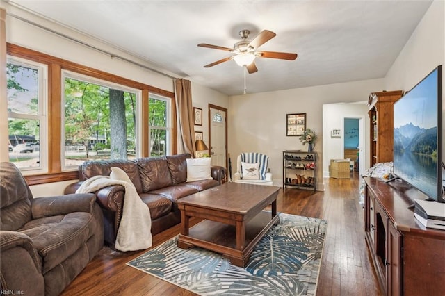 living area featuring dark wood-style flooring and ceiling fan