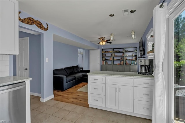 kitchen featuring a ceiling fan, stainless steel dishwasher, light tile patterned flooring, visible vents, and white cabinetry