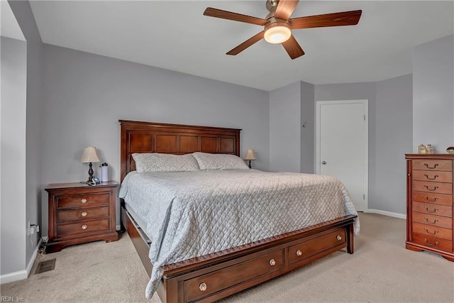 bedroom with light carpet, baseboards, visible vents, and ceiling fan