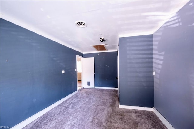 carpeted empty room with visible vents and baseboards