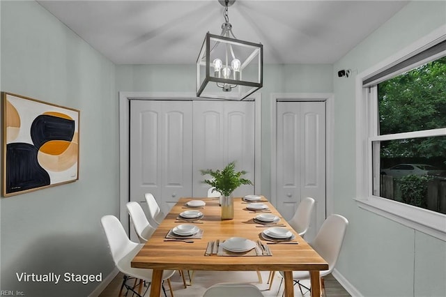 912 W 31st St, Norfolk, VA 23508 - dining room featuring a chandelier, baseboards, and wood finished floors