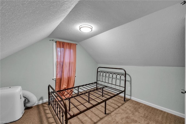 912 W 31st St, Norfolk, VA 23508 - carpeted bedroom with vaulted ceiling, a textured ceiling, and baseboards