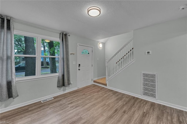 912 W 31st St, Norfolk, VA 23508 - foyer entrance featuring a textured ceiling, visible vents, wood finished floors, and stairway