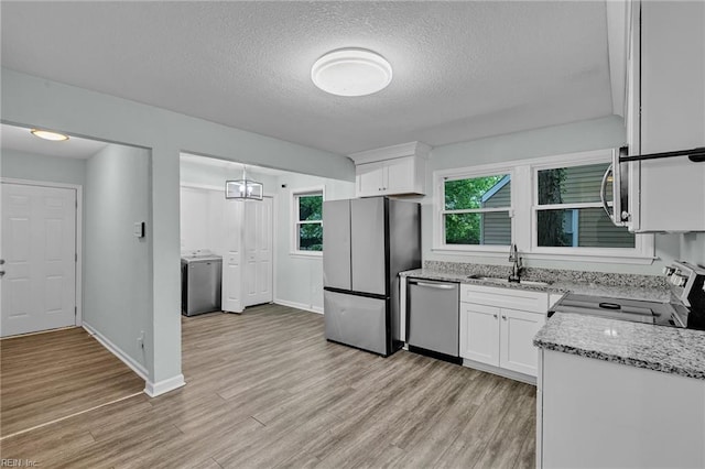 912 W 31st St, Norfolk, VA 23508 - kitchen with white cabinetry, stainless steel appliances, washer / clothes dryer, and a sink