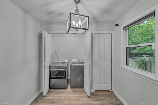 912 W 31st St, Norfolk, VA 23508 - laundry area featuring an inviting chandelier, washing machine and clothes dryer, laundry area, baseboards, and light wood-style floors