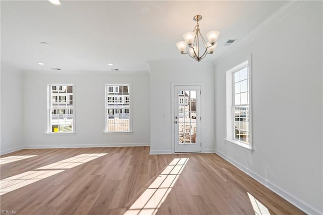 interior space featuring light wood-style flooring, recessed lighting, an inviting chandelier, visible vents, and crown molding